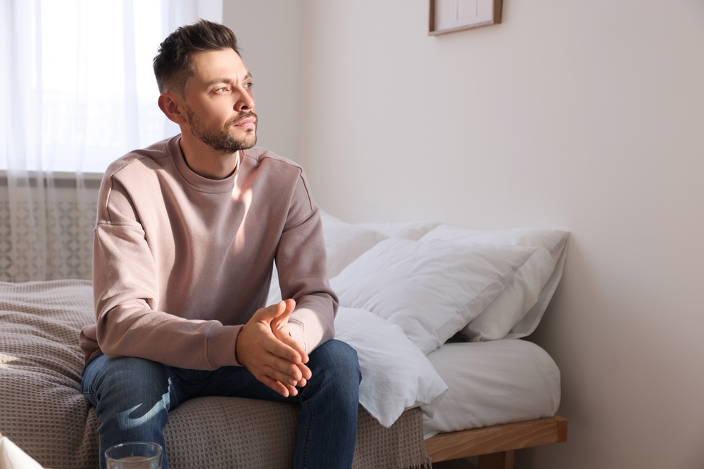 Upset man sulking at home - Loneliness concept